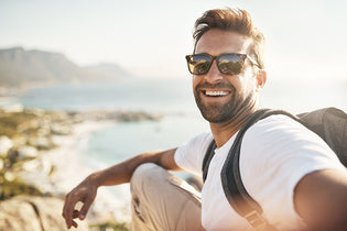 Selfies with a view. Cropped portrait of a handsome young man taking selfies wearing reading sunglasses,  while hiking in the mountains.