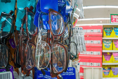 Many Reading glasses on a rack stand, Inside the Dollar tree store.